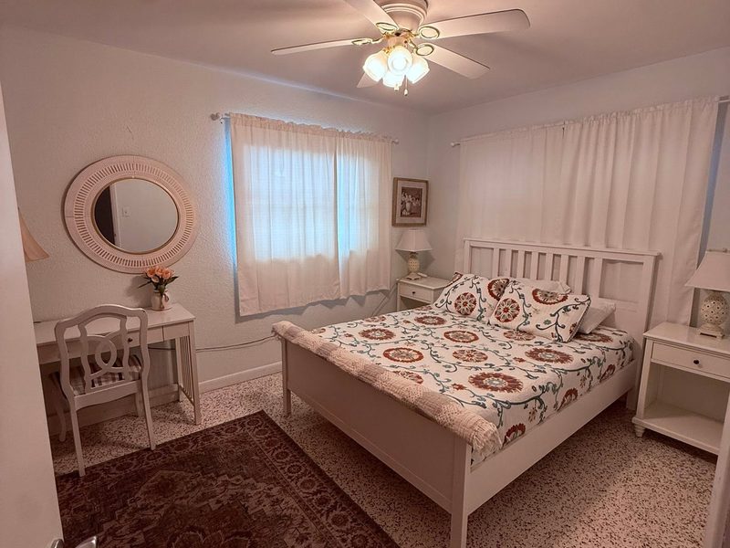 Bedroom made up with fresh linens and vacuumed floors during a rental turnover
