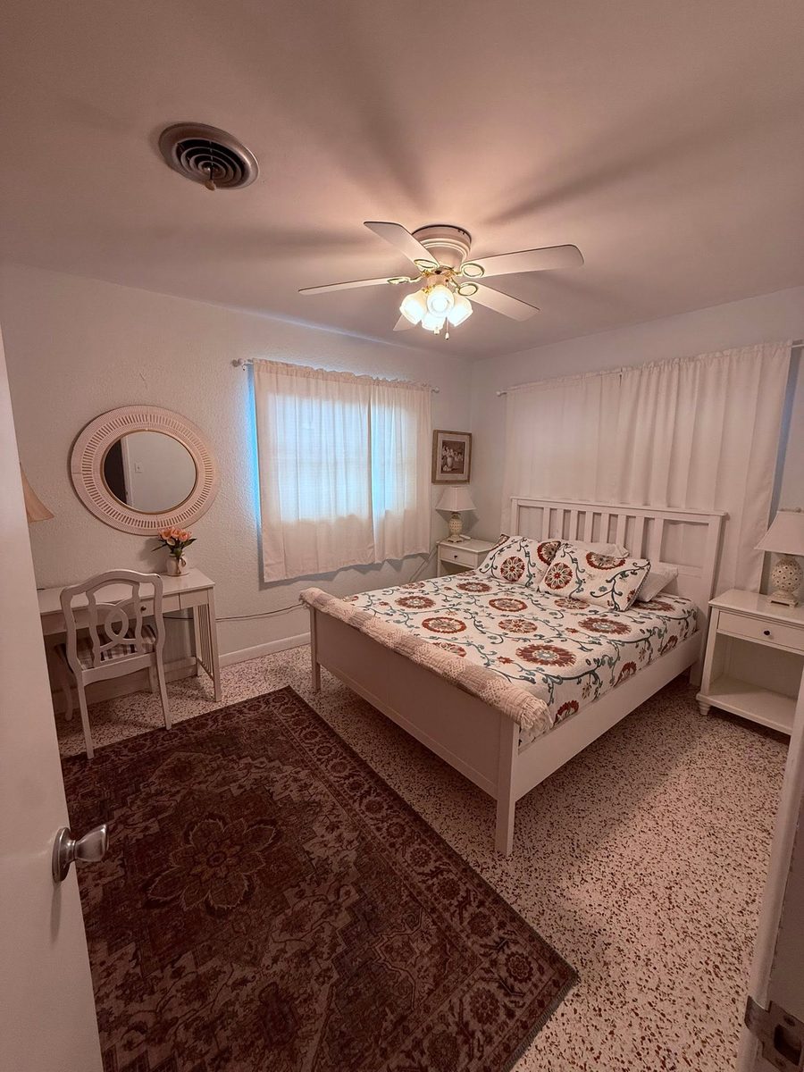 Bedroom made up with fresh linens and vacuumed floors during a rental turnover