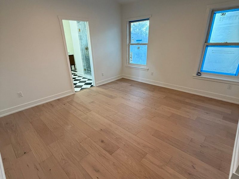 Empty room with hardwood floors cleaned and ready for a move-in walkthrough