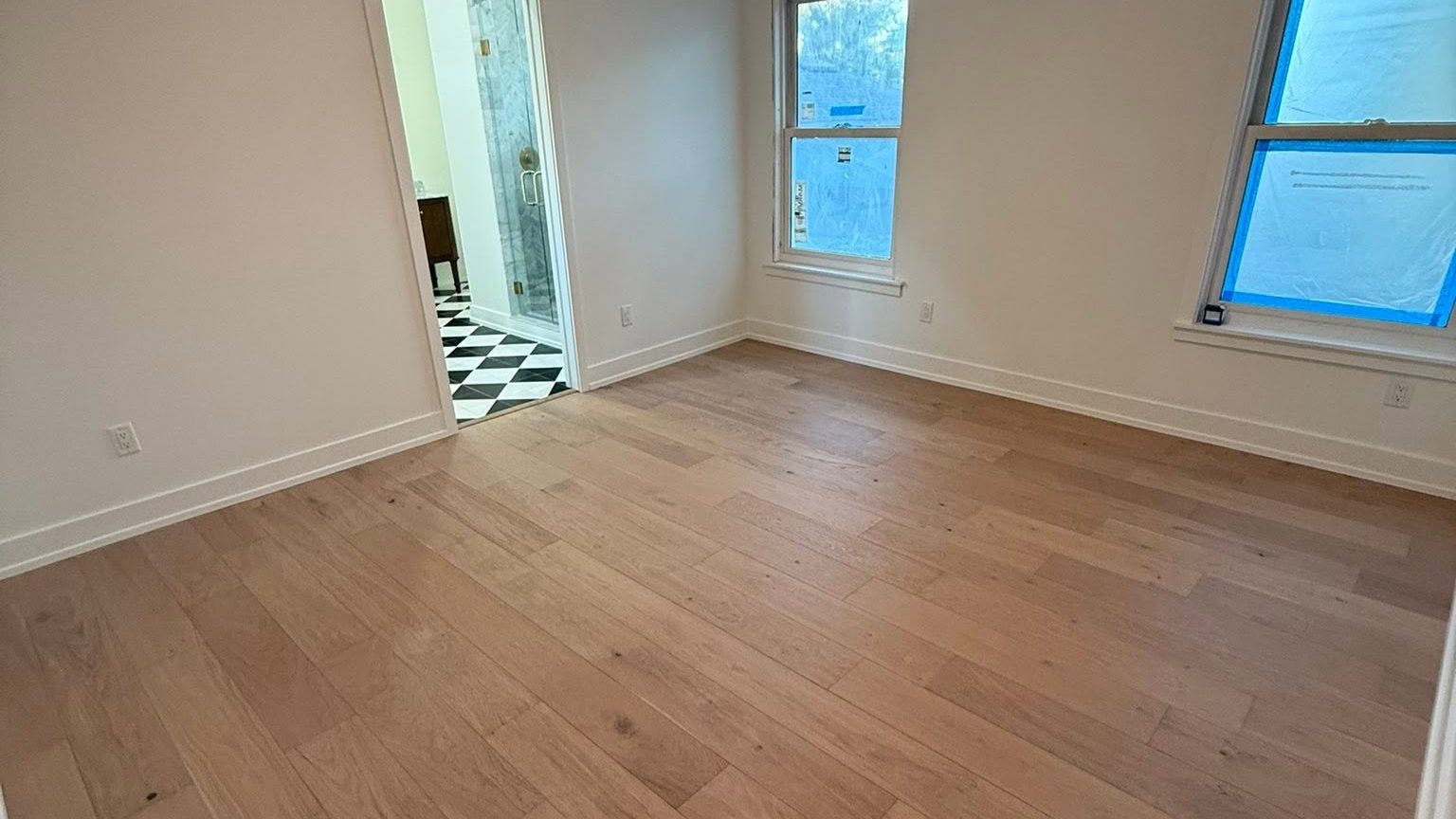 Empty room with hardwood floors cleaned and ready for a move-in walkthrough