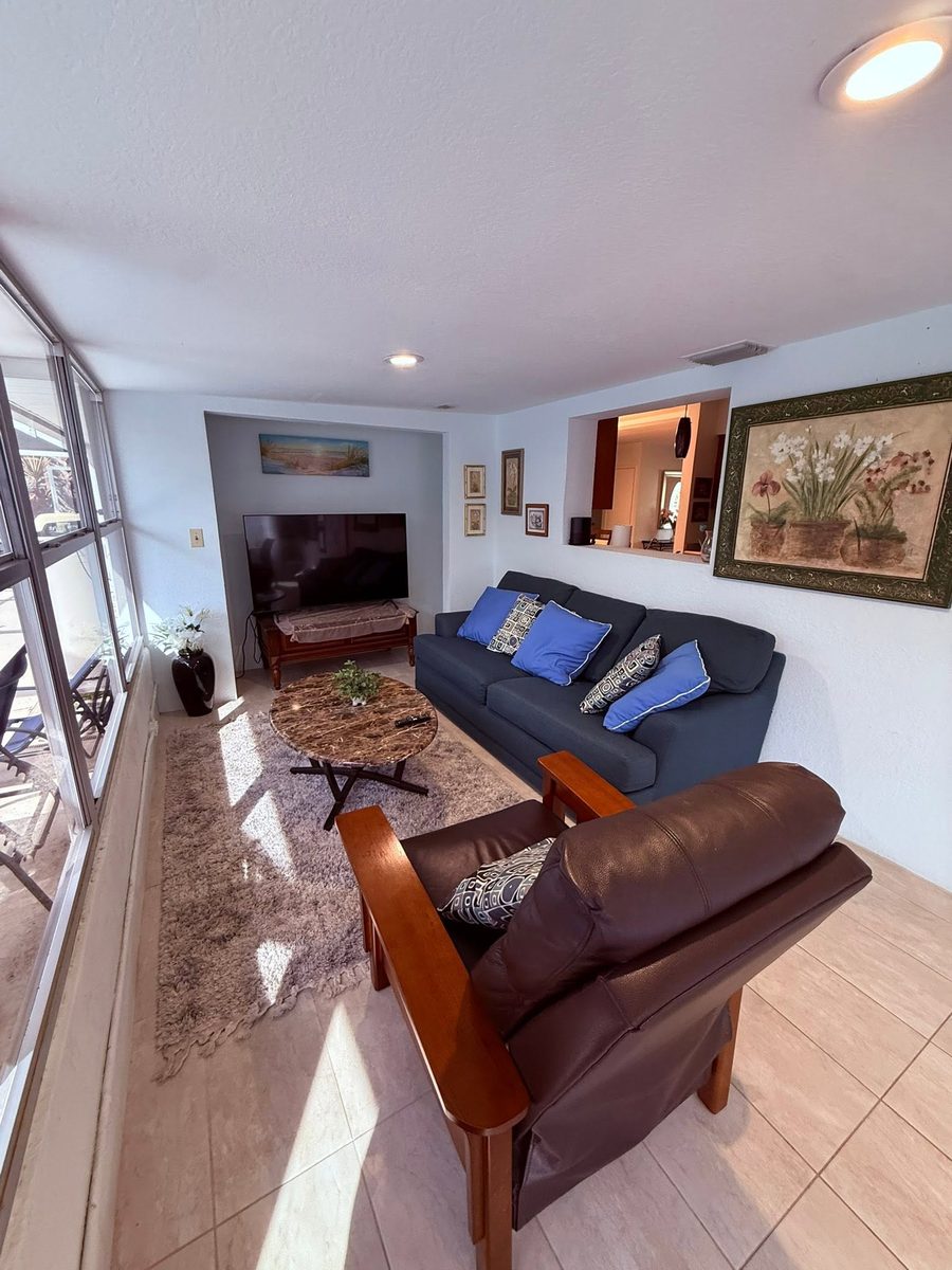 Sunlit living room with a tiled floor and clean glass doors after a Krispy Clean visit