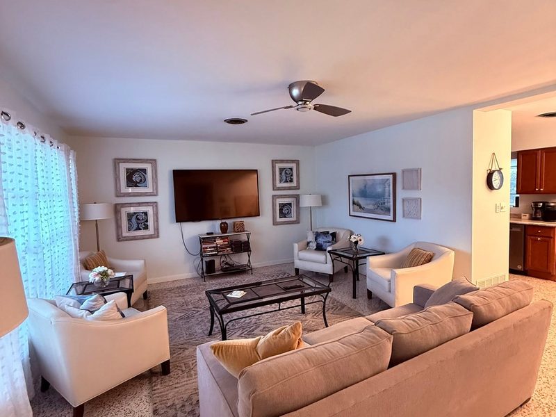 Freshly cleaned living room with a sectional sofa, coffee table and vacuumed carpet